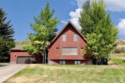 exterior space with a lawn, driveway, and a garage