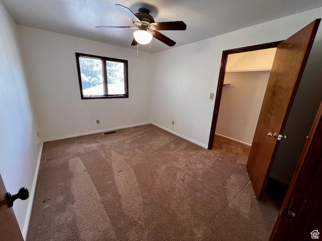 1752 Cedar View Rd, Soda Springs, ID 83276 - unfurnished bedroom with carpet flooring, baseboards, a ceiling fan, and a walk in closet