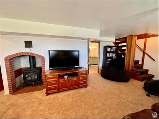 1752 Cedar View Rd, Soda Springs, ID 83276 - living room featuring a wood stove, light colored carpet, and stairway
