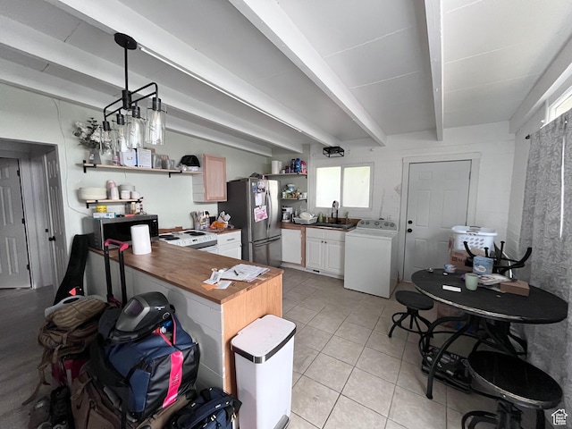 3766 S Orchard Ave E, South Ogden, UT 84403 - kitchen featuring washer / dryer, stainless steel appliances, open shelves, light tile patterned floors, and beam ceiling