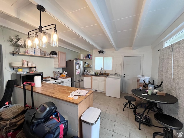 3766 S Orchard Ave E, South Ogden, UT 84403 - kitchen featuring washer / clothes dryer, open shelves, stainless steel appliances, plenty of natural light, and beamed ceiling