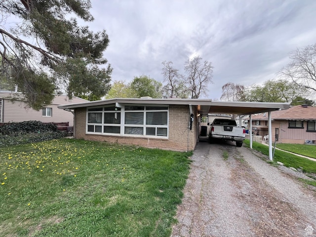 3766 S Orchard Ave E, South Ogden, UT 84403 - view of front of home with driveway, brick siding, a front lawn, and an attached carport