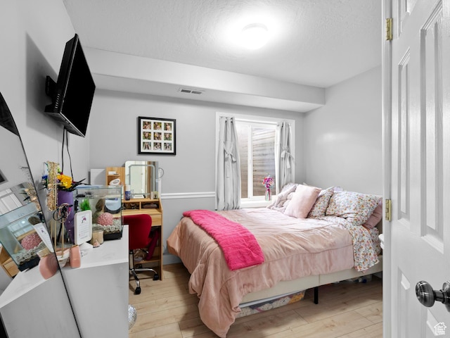1415 S Bridgeview Dr W, Layton, UT 84041 - bedroom featuring a textured ceiling, visible vents, and light wood-type flooring