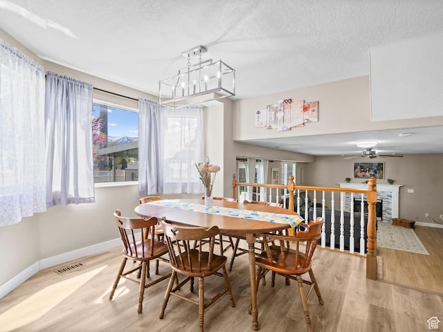 1415 S Bridgeview Dr W, Layton, UT 84041 - dining room with baseboards, ceiling fan, light wood-type flooring, and visible vents