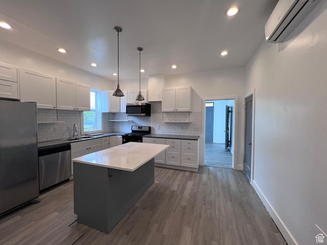 172 N 300 W, Logan, UT 84321 - kitchen with decorative backsplash, dark wood-style floors, a wall unit AC, a sink, and appliances with stainless steel finishes