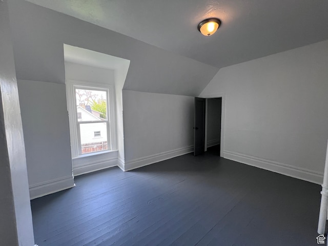 172 N 300 W, Logan, UT 84321 - bonus room with dark wood-style flooring, baseboards, and vaulted ceiling