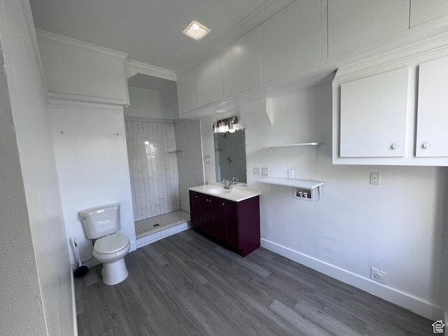 172 N 300 W, Logan, UT 84321 - bathroom with vanity, ornamental molding, wood finished floors, toilet, and tiled shower