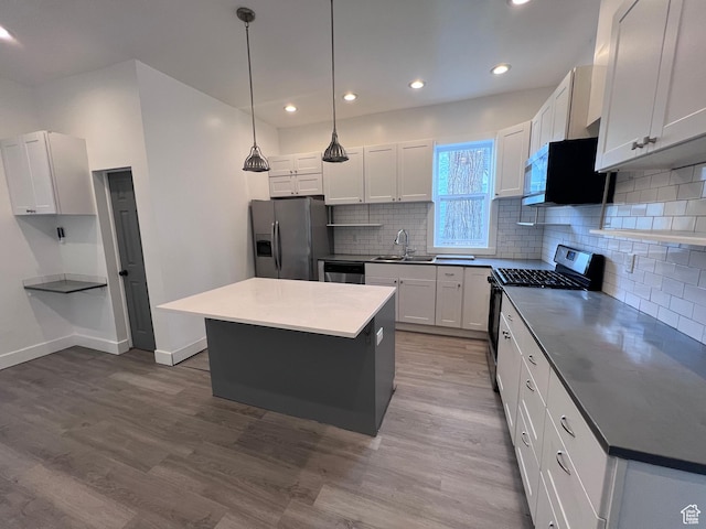 172 N 300 W, Logan, UT 84321 - kitchen with a sink, tasteful backsplash, stainless steel appliances, and wood finished floors