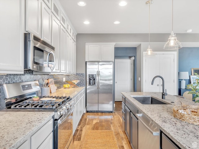 2813 W Hidden Moose Ln, Lehi, UT 84043 - kitchen featuring light wood-type flooring, a sink, white cabinetry, and stainless steel appliances