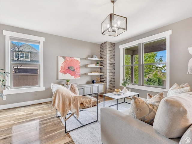 2813 W Hidden Moose Ln, Lehi, UT 84043 - living area with an inviting chandelier, light wood finished floors, baseboards, and a wealth of natural light