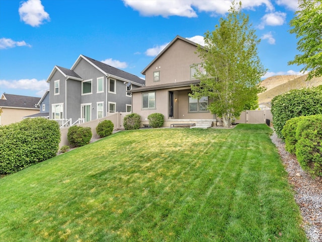 2813 W Hidden Moose Ln, Lehi, UT 84043 - rear view of property with a lawn, a gate, a fenced backyard, and stucco siding