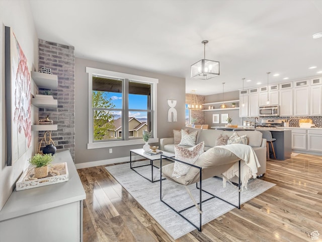 2813 W Hidden Moose Ln, Lehi, UT 84043 - living room with recessed lighting, baseboards, a chandelier, and light wood finished floors