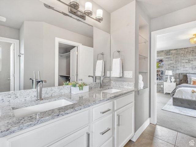 2813 W Hidden Moose Ln, Lehi, UT 84043 - bathroom featuring double vanity, a sink, connected bathroom, and tile patterned floors