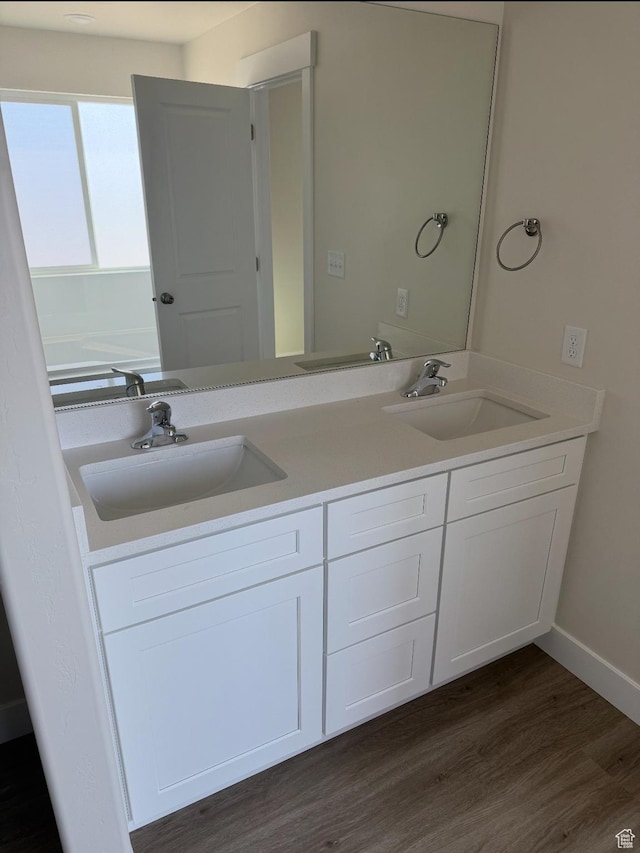 1097 N 580 E, Nephi, UT 84648 - bathroom featuring double vanity, baseboards, a sink, and wood finished floors