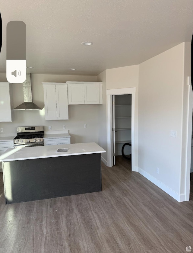 1097 N 580 E, Nephi, UT 84648 - kitchen with wall chimney range hood, dark wood-style flooring, white cabinets, baseboards, and gas range