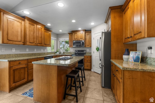 454 N 3550 W, Layton, UT 84041 - kitchen featuring appliances with stainless steel finishes, a kitchen bar, brown cabinetry, a center island, and recessed lighting