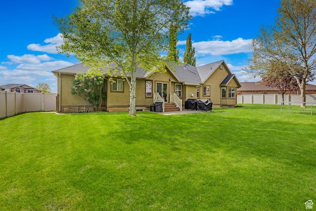 454 N 3550 W, Layton, UT 84041 - back of house with stucco siding, a fenced backyard, and entry steps