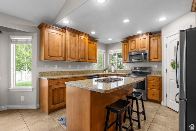 454 N 3550 W, Layton, UT 84041 - kitchen with appliances with stainless steel finishes, light tile patterned floors, brown cabinets, and recessed lighting