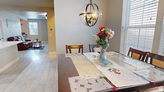 10627 S Lake Terrace Ave S, South Jordan, UT 84009 - dining room featuring ceiling fan, wood finished floors, a chandelier, and baseboards