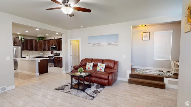 10627 S Lake Terrace Ave S, South Jordan, UT 84009 - living room with light wood-style floors, ceiling fan, recessed lighting, and baseboards
