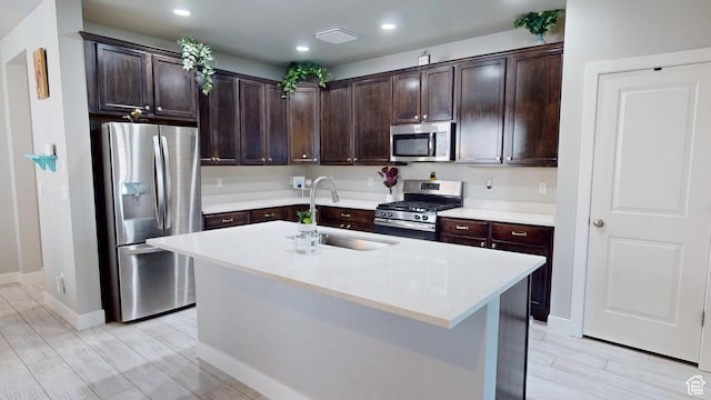10627 S Lake Terrace Ave S, South Jordan, UT 84009 - kitchen featuring stainless steel appliances, a sink, dark brown cabinetry, wood tiled floors, and recessed lighting