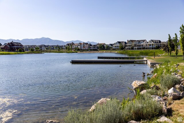 10627 S Lake Terrace Ave S, South Jordan, UT 84009 - water view with nearby suburban area, a floating dock, and mountains