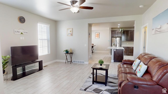 10627 S Lake Terrace Ave S, South Jordan, UT 84009 - living room featuring a ceiling fan, light wood-style floors, and baseboards