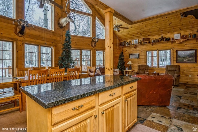 4417 Buck Way Unit 2029, Heber City, UT 84032 - kitchen featuring a kitchen island, open floor plan, ceiling fan, wooden walls, and high vaulted ceiling