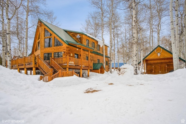 4417 Buck Way Unit 2029, Heber City, UT 84032 - snow covered back of property with log exterior, metal roof, and a wooden deck