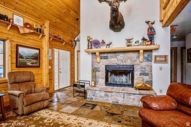 4417 Buck Way Unit 2029, Heber City, UT 84032 - living area with stone tile flooring, wood walls, a stone fireplace, high vaulted ceiling, and wood ceiling