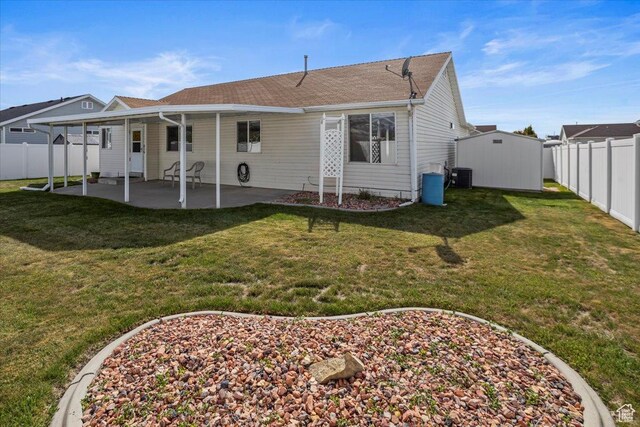 5448 S 4025 W, Roy, UT 84067 - rear view of property with a patio, a shed, a fenced backyard, central AC unit, and an outdoor structure