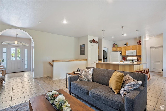3072 S 1065 W, Syracuse, UT 84075 - living room with light tile patterned floors, arched walkways, baseboards, and recessed lighting