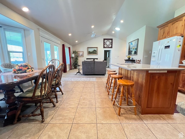 1003 E 200 S, American Fork, UT 84003 - kitchen with white fridge with ice dispenser, lofted ceiling, a center island, light tile patterned flooring, and light countertops