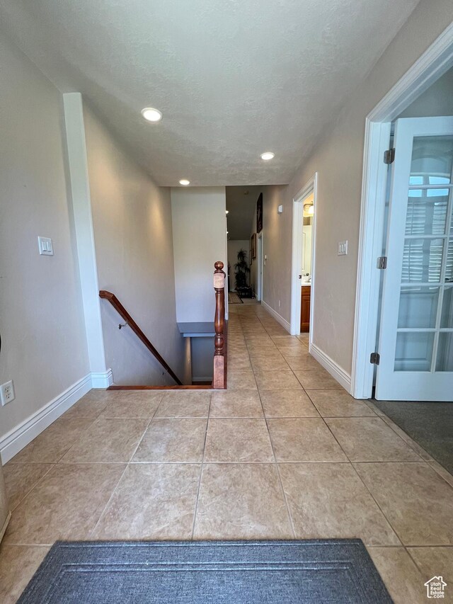 1003 E 200 S, American Fork, UT 84003 - hallway featuring an upstairs landing, tile patterned flooring, recessed lighting, baseboards, and a textured ceiling