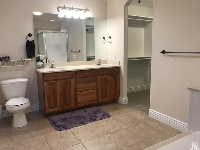 1003 E 200 S, American Fork, UT 84003 - bathroom featuring a shower stall, toilet, double vanity, baseboards, and tile patterned flooring
