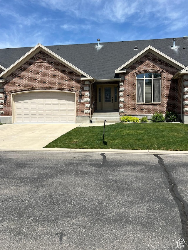 1003 E 200 S, American Fork, UT 84003 - view of front of property with brick siding, concrete driveway, a front yard, a garage, and a shingled roof