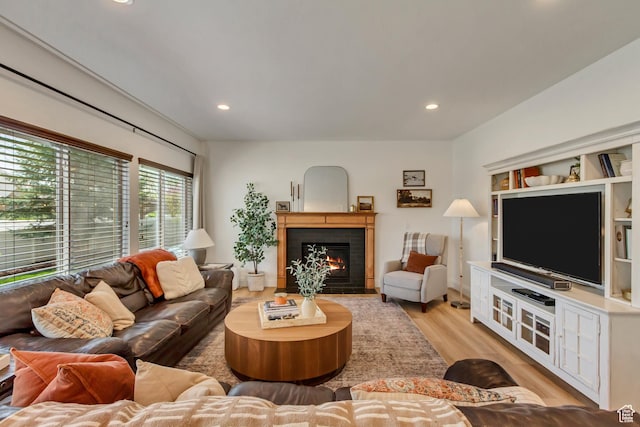 3381 W Slate View Dr, South Jordan, UT 84095 - living room with recessed lighting, light wood-type flooring, and a warm lit fireplace