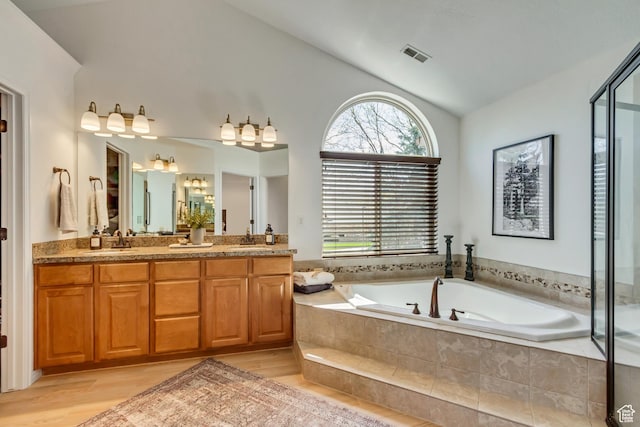 3381 W Slate View Dr, South Jordan, UT 84095 - full bath with visible vents, a sink, a bath, and vaulted ceiling