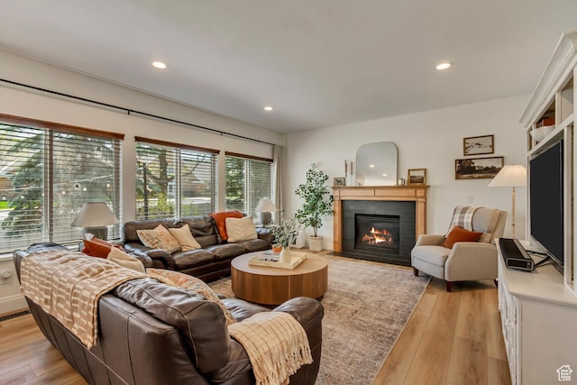 3381 W Slate View Dr, South Jordan, UT 84095 - living area featuring a fireplace with flush hearth, recessed lighting, and light wood-type flooring