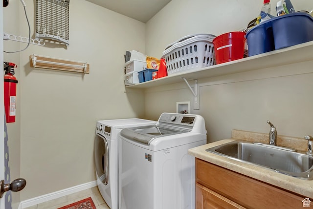 3381 W Slate View Dr, South Jordan, UT 84095 - laundry area with baseboards, separate washer and dryer, a sink, cabinet space, and light tile patterned floors
