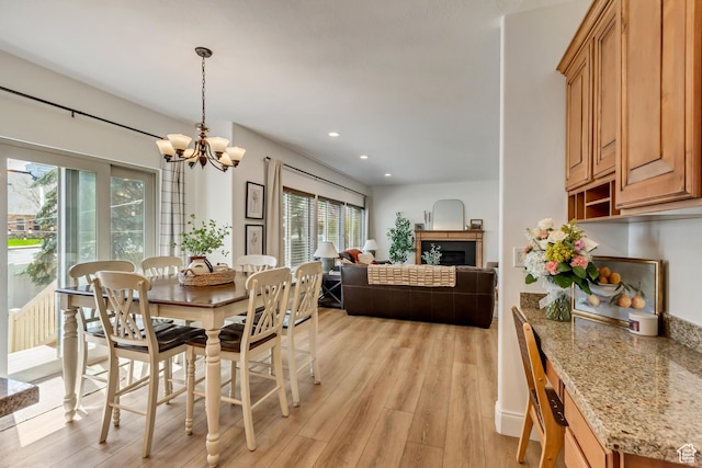 3381 W Slate View Dr, South Jordan, UT 84095 - dining room with recessed lighting, a chandelier, light wood-style flooring, and a fireplace
