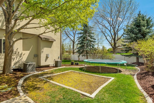 3381 W Slate View Dr, South Jordan, UT 84095 - view of yard featuring central AC, a fenced backyard, and a trampoline