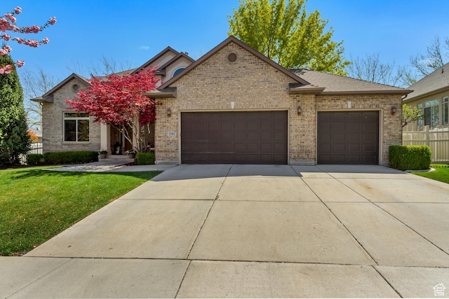 3381 W Slate View Dr, South Jordan, UT 84095 - view of front of house with a garage, a front lawn, fence, brick siding, and concrete driveway