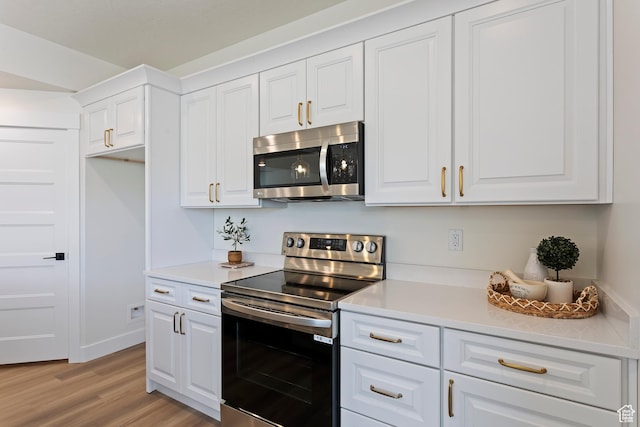 3238 S 4950 W, West Haven, UT 84401 - kitchen featuring light wood-type flooring, light countertops, white cabinets, and stainless steel appliances