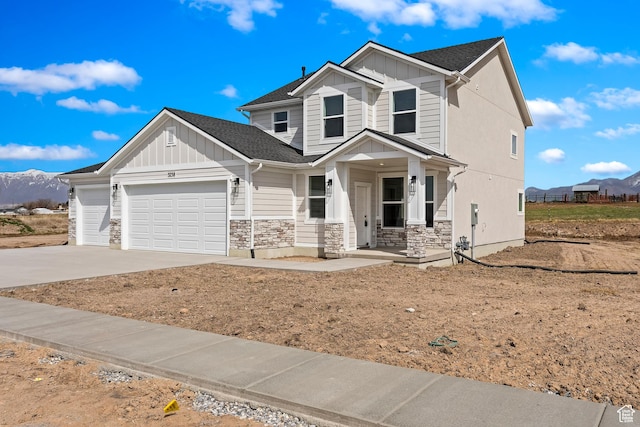craftsman house featuring board and batten siding, an attached garage, concrete driveway, and stone siding
