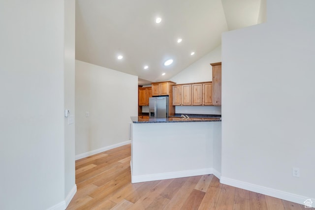 487 W 350 S Unit D, Springville, UT 84663 - kitchen featuring a peninsula, stainless steel fridge, dark stone counters, recessed lighting, and light wood-style flooring