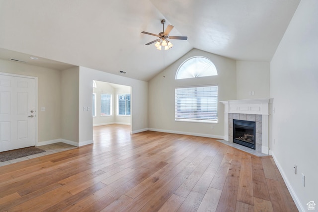 487 W 350 S Unit D, Springville, UT 84663 - unfurnished living room with light wood-style floors, a tiled fireplace, ceiling fan, and lofted ceiling