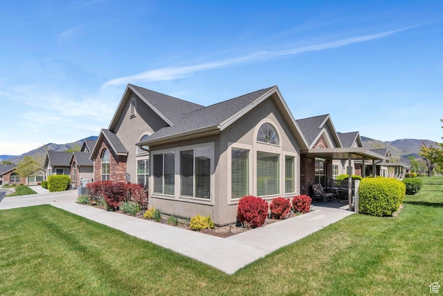 487 W 350 S Unit D, Springville, UT 84663 - view of side of home with a mountain view, stucco siding, and a yard