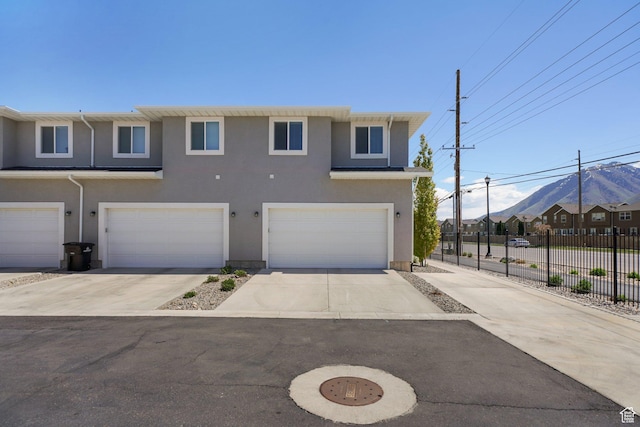 825 S 1710 E, Spanish Fork, UT 84660 - townhome / multi-family property featuring an attached garage, fence, driveway, and stucco siding