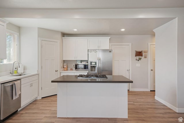 825 S 1710 E, Spanish Fork, UT 84660 - kitchen with white cabinets, stainless steel appliances, a sink, and light wood-type flooring